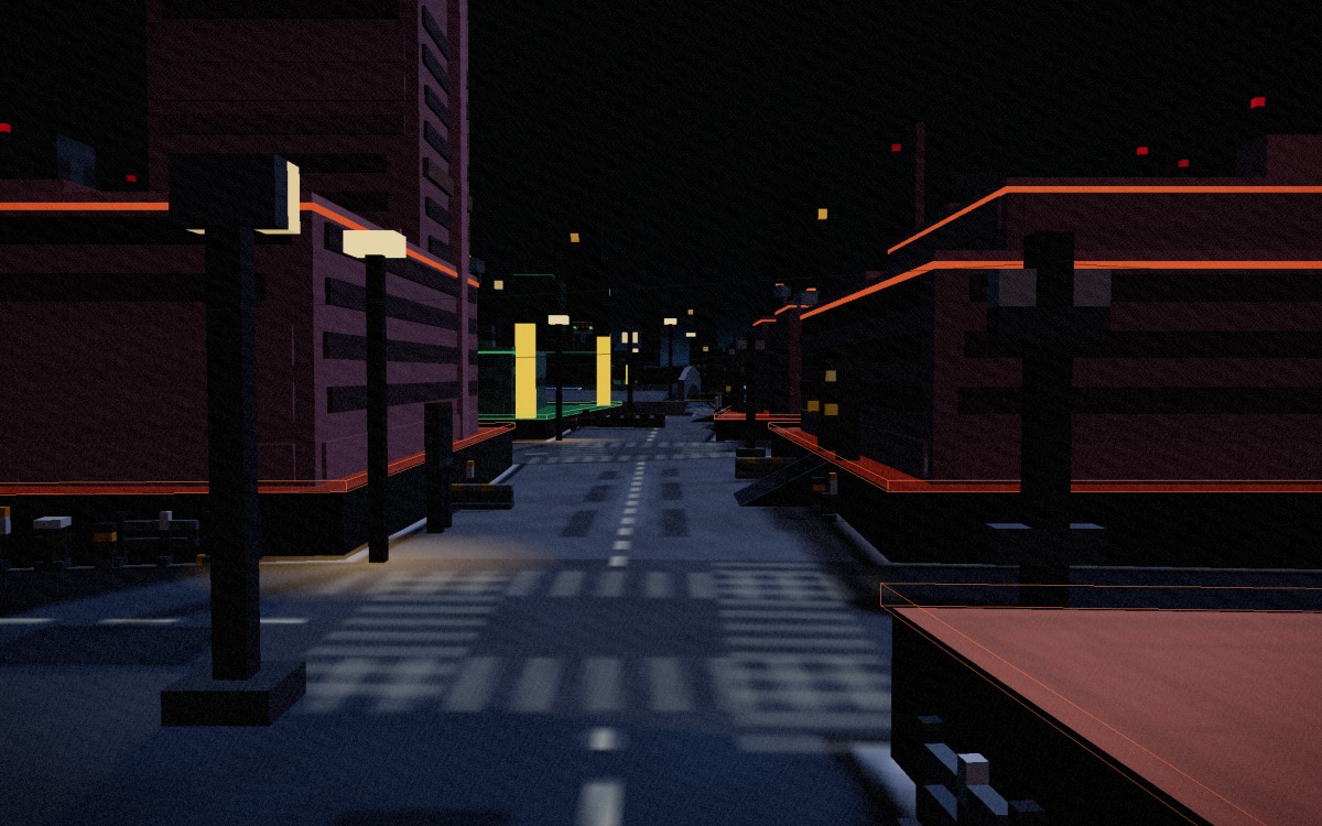 A wide street at night running between two lit Ember blocks on their plinths